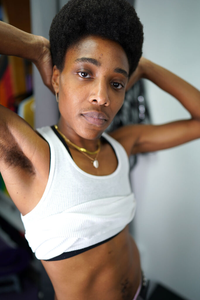 A butch stud lesbian in a white tank top